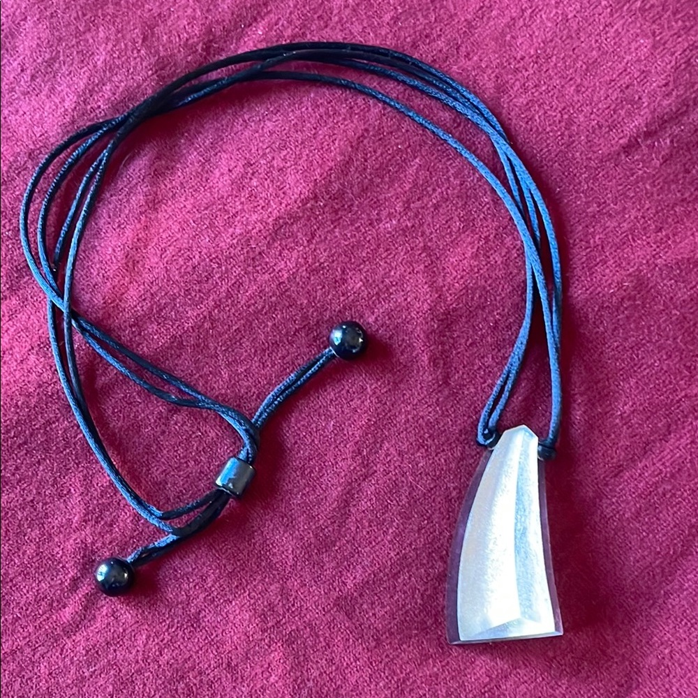 Zsiska clear & silver geometric pendant with adjustable black satin cord.